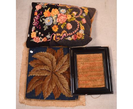 An 1825 cross stitch alphabet sampler in ebonised frame, a small tapestry and a vintage tapestry cushion (3).