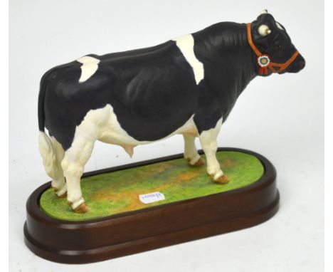 Royal Worcester; a figure of a 'British Friesian Bull' modelled by Doris Lindner 1964, on fitted wooden plinth, height 21cm.