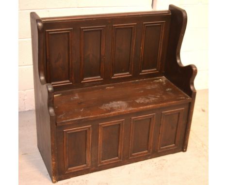 A stained pine hall bench with hinged storage seat, width 92cm.