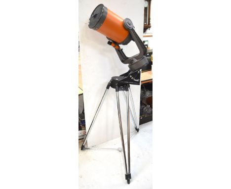 A boxed Celestron 8 astronomical telescope with lock triangle tripod, drive corrector, with accessories to include a Barlow l