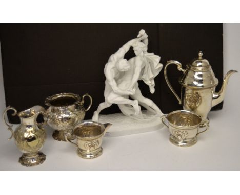 A three-piece Art Deco style plated tea service comprising teapot, milk jug and sugar bowl, a further plated milk jug and twi