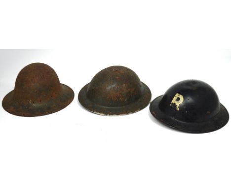 Three helmets to include a WWII ARP helmet with liner, a WWII British helmet with liner and a WWI British helmet (3).