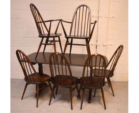 An Ercol 'Old Colonial' elm rectangular dining table, length 150cm and a set of six (4+2) stick-back dining chairs (7).