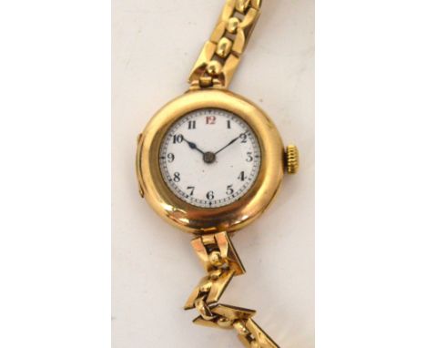 A 9ct gold ladies' wristwatch, circular enamel dial set with Roman numerals, on gold-plated bracelet strap.