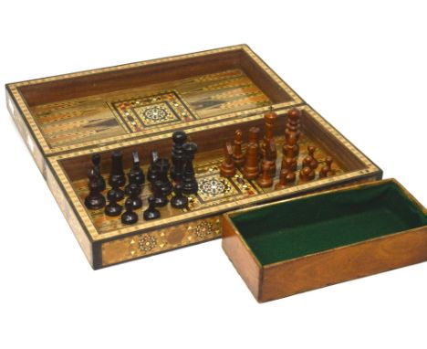 An inlaid backgammon board and a box containing carved wooden chess pieces (2).