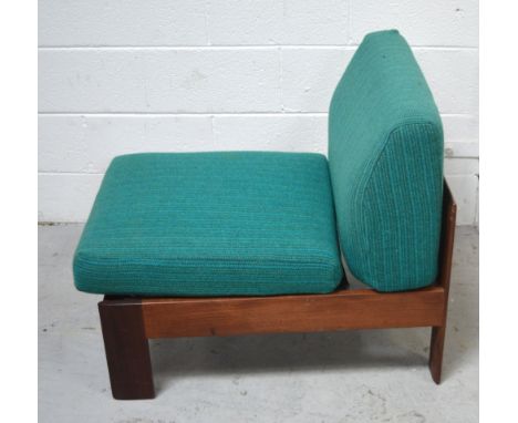 A 1960s teak low chair with Harris Tweed turquoise cushion covers.