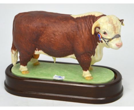 Royal Worcester; a figure of a 'Hereford Bull' modelled by Doris Lindner 1959, on fitted wooden plinth, height 20cm.