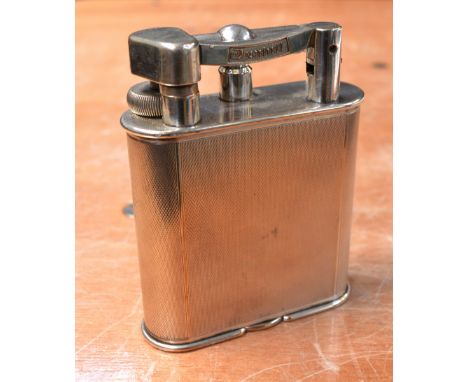 A vintage Dunhill engine-turned table lighter, registration no.737418, height 10cm.