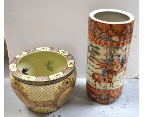 A large Oriental ceramic fish bowl with vine and grape decoration, and a Chinese porcelain stick stand with chrysanthemum and