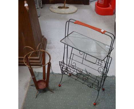 A 1950s metal and teak umbrella stand modelled as an umbrella and a magazine rack with musical note decoration and glass shel