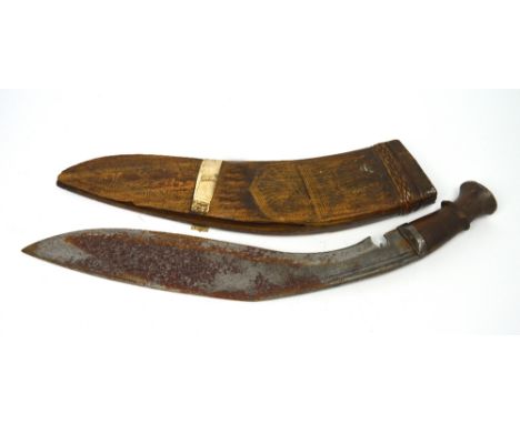 A Gurkha kukri knife in carved wooden scabbard, length approx 53cm.