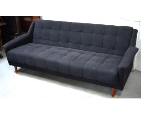 A 1950s black button upholstered sofa bed, approx length 220cm.