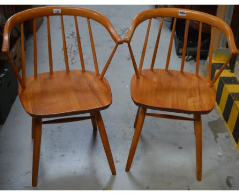 A pair of Danish-style beech carver chairs with stick backs and teak Danish-style armchair with tweed upholstered back and se