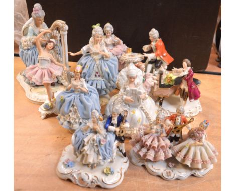 Nine Dresden-style figures to include some Dresden lace-style figures, a ballet dancer, a lady playing the harp, a couple in 