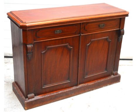 A Victorian mahogany buffet sideboard with canted top edge, two drawers over two cupboard doors opening to single shelf and i