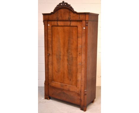 A Victorian mahogany single-door wardrobe with curved carved frieze, reeded supports to bracket feet, 182 x 90cm.