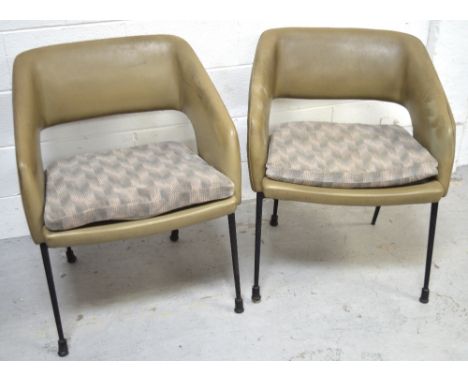 A pair of 1960s green vinyl-upholstered chairs with cushion seats on black metal legs.