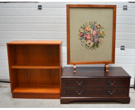 A mahogany fall-front TV cabinet with cross-banded decoration, a 1970s teak bookcase and a 1940s oak-framed tapestry fire scr