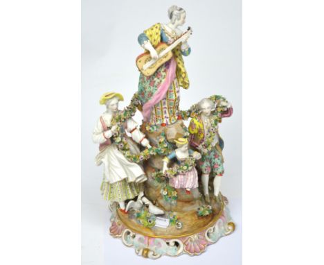 Meissen; an early 19th century figural and floral table centre, young woman on a rocky floral encrusted outcrop playing a gui