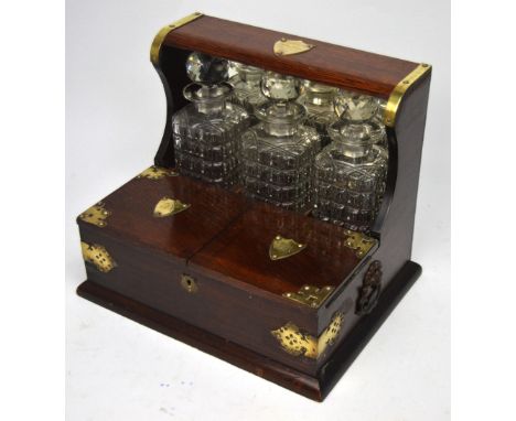 An Edwardian oak tantalus and cigarette box with brass furniture, shield-shaped plaque to top inscribed 'From a Few Old 'Glue