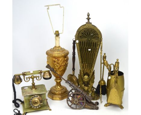 An ornate gilded lamp decorated with putti, an onyx and brass ornamental telephone and a quantity of brassware to include a f