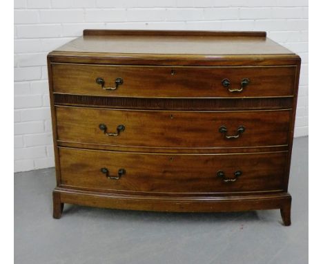 A mahogany ledgeback bow front chest with three long graduating drawers on shaped apron support