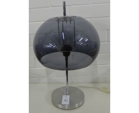 A Guzzini style table lamp with blue glass shade on a brushed metal stem and circular base, 