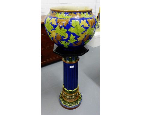 A continental pottery jardiniere stand, together with an associated planter, (2) 