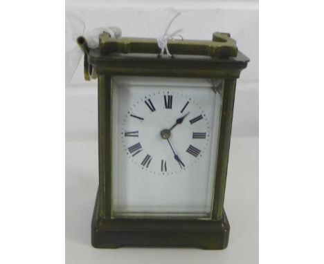 A French brass and glass panelled carriage clock, with loop handle to top, 14cm high 