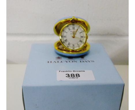 A Halcyon Days 'Time Flies - Friendship Stays' travelling alarm clock, complete with a pale blue leather pouch and box 