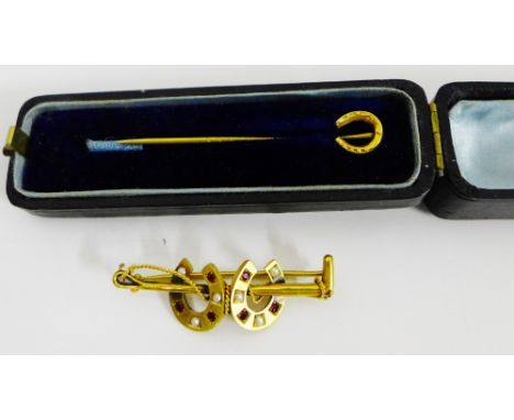 A 9 carat gold horseshoe tie pin in its fitted box together with a ruby and seed pearl double horseshoe brooch, set in yellow