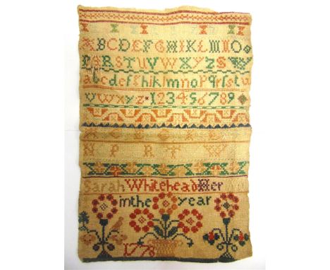 AN 18TH CENTURY SAMPLER  comprising upper and lower case alphabet letters and numbers with horizontal decorative bands and a 