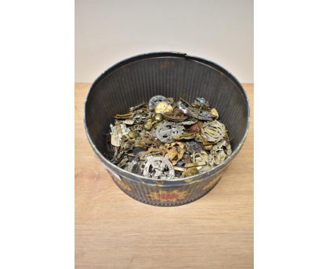 A tin of Military Cap Badges, Cloth Badges and Buttons, many regiments seen including Cheshire, The Kings, Artillery, Army Or