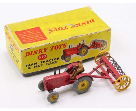 Dinky Toys box No. 310 farm tractor and hayrake, comprising Massey Harris tractor finished in red and yellow with matching ha