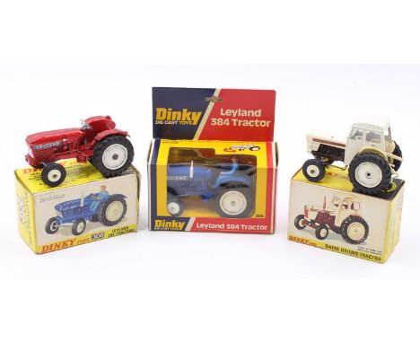 A collection of three various boxed Dinky Toy diecast farming agricultural tractors to include a No. 308 Leyland 384 tractor 