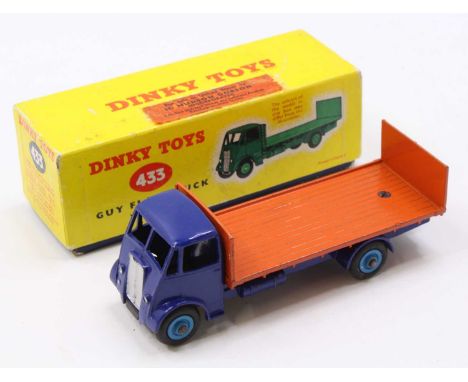 Dinky Toys No. 433 guy flat truck comprising of a dark blue cab and chassis with light blue hubs and orange back, housed in t