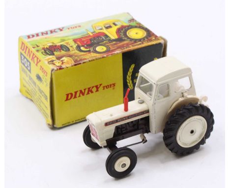 A Dinky Toys No. 305 David Brown tractor comprising of white and brown body with red smoke stack, housed in the original pict