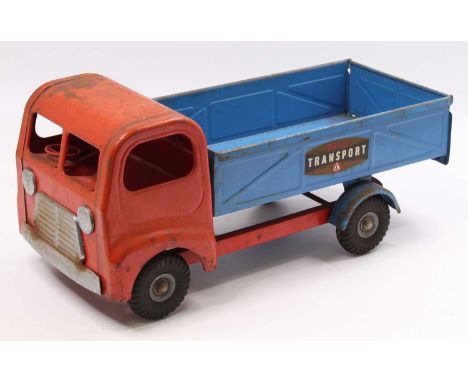 A Triang large scale pressed steel model of a Triang Transport tipper, comprising red cab and chassis with blue back, with Tr