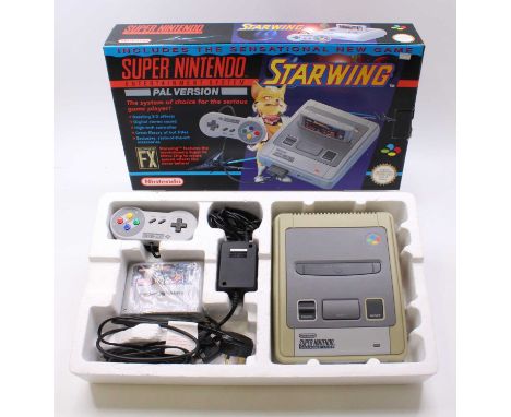 A Nintendo SNES Super Nintendo Entertainment System (PAL version) comprising of console, power leads, Star Wing game, hand co