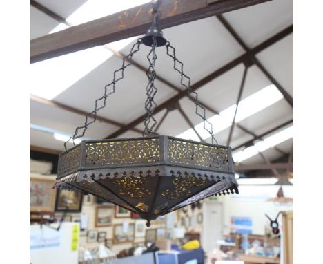 An octagonal pierced metal hanging light fitting, with amber glass inserts, 53cm across 