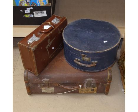 A travel trunk, a hat box, and a small suitcase 
