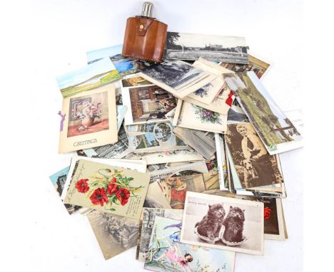 A box of assorted postcards, plus a leather-bound hip flask 