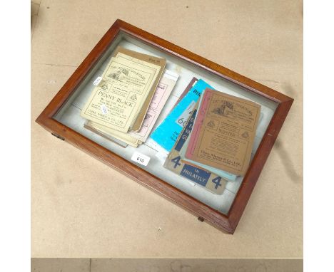 A table-top display case, with a collection of brochures and stamp catalogues 