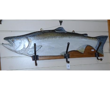 Painted salmon coat hooks on wooden plaque, by Clive Fredriksson, signed, length 28cm 