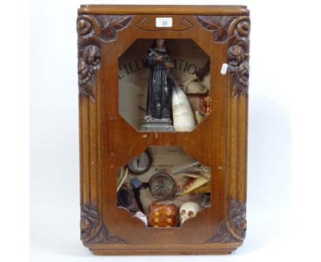 A clock case containing a display of religious items, skull, compass etc, height overall 61cm