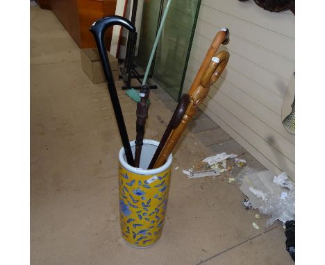 A ceramic stick stand, and 5 walking sticks 