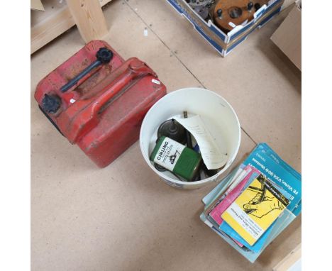 2 Vintage petrol cans, largest 2 gallons, various car manuals, funnels etc 
