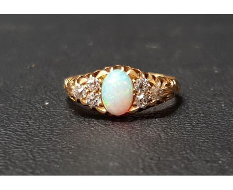 EDWARDIAN OPAL AND DIAMOND RINGthe central oval cabochon opal flanked by three diamonds to each side, the diamonds totalling 