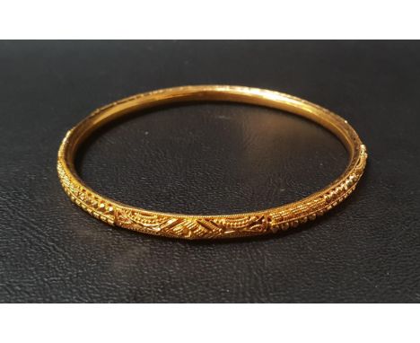 TWENTY-TWO CARAT GOLD BANGLEwith relief detail, approximately 10.3 grams 