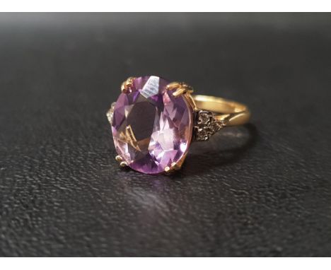 AMETHYST AND DIAMOND DRESS RINGthe central oval cut amethyst measuring 12.1mm x 10mm x 5.6mm, flanked by three small diamonds